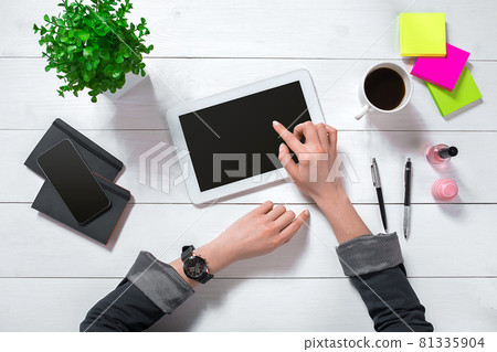 Overhead view of businesswoman working at computer in office Overhead view of businesswoman working at computer in office 81335904