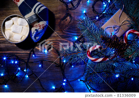 Christmas homemade hot chocolate with marshmallows in the hands of woman, top view. Christmas homemade hot chocolate with marshmallows in the hands of woman, top view. 81336009