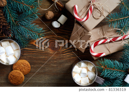 Christmas drink. Mug hot coffee with marshmallow, red candy cane on the wooden background. New Year. Christmas drink. Mug hot coffee with marshmallow, red candy cane on the wooden background. New Year. 81336319
