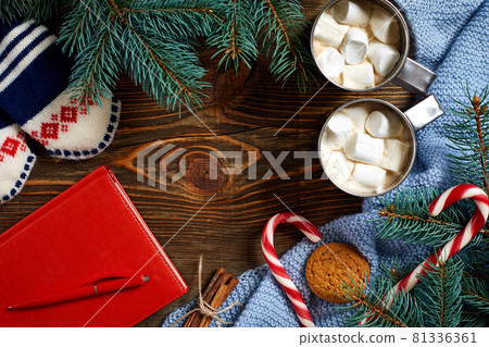 Christmas drink. Mug hot coffee with marshmallow, red candy cane on the wooden background. New Year. Christmas drink. Mug hot coffee with marshmallow, red candy cane on the wooden background. New Year. 81336361