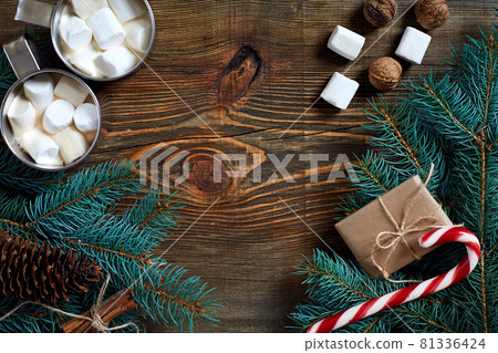 Cocoa with marshmallow, chocolate and spruce branches on a wooden background Cocoa with marshmallow, chocolate and spruce branches on a wooden background 81336424