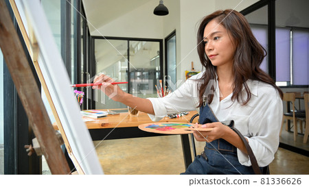 Professional female painter, painting on large canvas easel Professional female painter, painting on large canvas easel 81336626