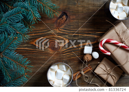 Cocoa with marshmallow, chocolate and spruce branches on a wooden background 81336724