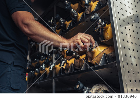 Male firefighter holding fire extinguisher in truck Male firefighter holding fire extinguisher in truck 81336946