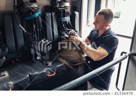 Fireman checking professional firefighting equipment Fireman checking professional firefighting equipment 81336979