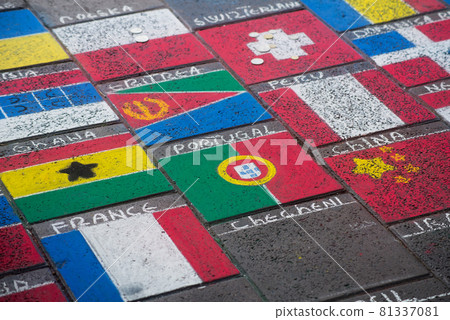 Closeup of world flags drawing in the street Closeup of world flags drawing in the street 81337081