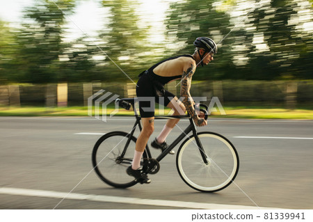 Young male cyclist riding a road bike in summer day. Sport, motion concept Young male cyclist riding a road bike in summer day. Sport, motion concept 81339941