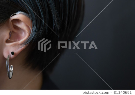 A small hearing aid that hides in your hair A small hearing aid that hides in your hair 81340691