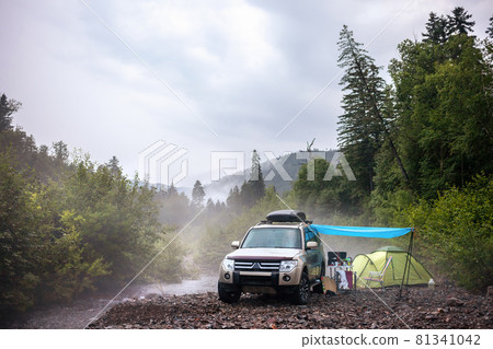 Car camping at mountain river 81341042