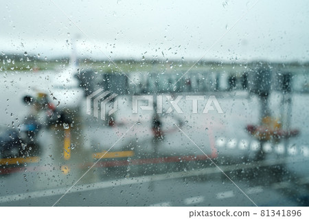 Airport aerodrome behind wet glass 81341896
