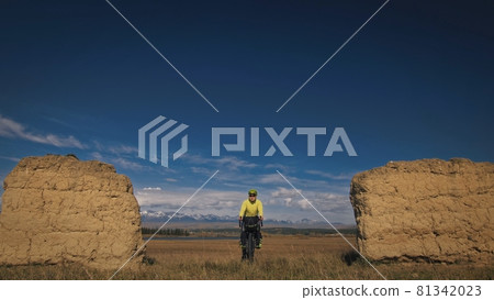 The man travel on mixed terrain cycle touring with bikepacking. The traveler journey with bicycle bags. Sport tourism bikepacking. The man travel on mixed terrain cycle touring with bikepacking. The traveler journey with bicycle bags. Sport tourism bikepacking. 81342023