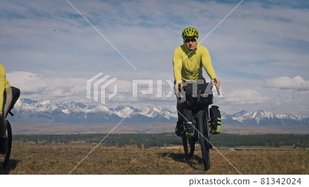 The man travel on mixed terrain cycle touring with bikepacking. The traveler journey with bicycle bags. Sport tourism bikepacking. 81342024