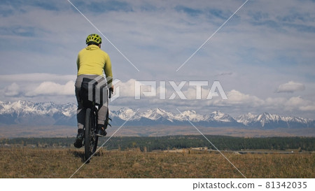 The man travel on mixed terrain cycle touring with bikepacking. The traveler journey with bicycle bags. Sport tourism bikepacking. 81342035