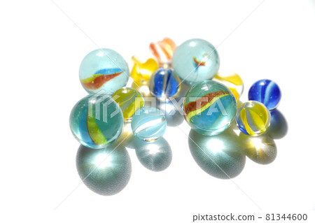 Multiple marbles on a white background shining in the back light 81344600