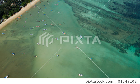 Aerial drone bird's eye view photo Top down of tropical sea with long tail fishing boats at phuket thailand Amazing tropical sea surface. Aerial drone bird's eye view photo Top down of tropical sea with long tail fishing boats at phuket thailand Amazing tropical sea surface. 81345105