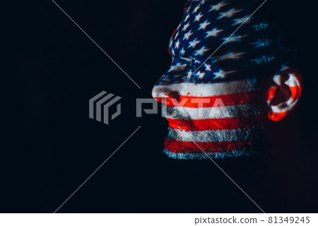 Adult man with USA flag on his face in the dark. Independence Day concept, Adult man with USA flag on his face in the dark. Independence Day concept, 81349245