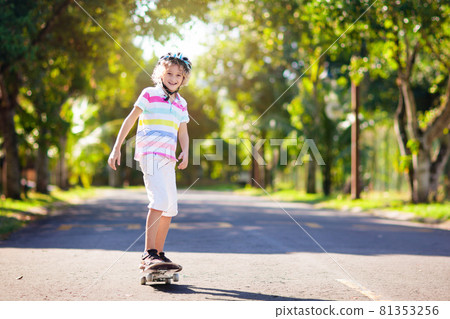 Kid with skateboard. Child riding skate board. Kid with skateboard. Child riding skate board. 81353256