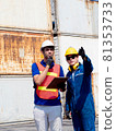 foreman engineer control wear red safety white hat talk businessmen manager company factory hold file report document information is pointing finger warehouse terminal container import export customer 81353733