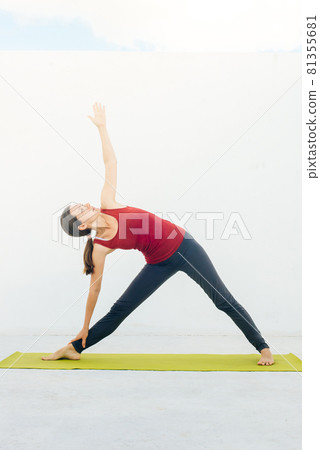 Side view portrait of beautiful young woman doing yoga or pilates exercise on white background Side view portrait of beautiful young woman doing yoga or pilates exercise on white background 81355681