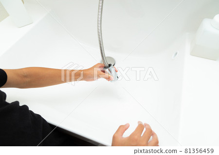 Girl cleaning the washbasin Girl cleaning the washbasin 81356459
