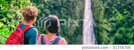 Hawaii travel tourists at nature waterfall panoramic landscape banner. Travelers couple looking at Akaka Falls in Big Island, Hawaiian famous attraction, USA 81356700