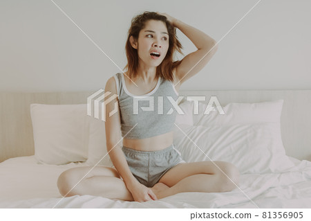 Attractive woman relax after wake up in bedroom. Summer vacation. Attractive woman relax after wake up in bedroom. Summer vacation. 81356905