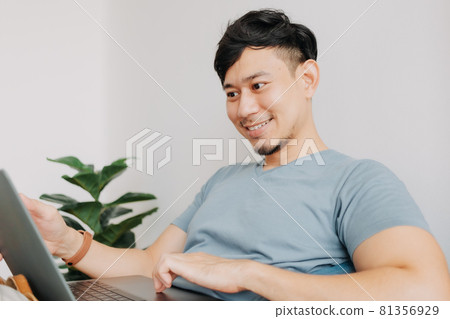 Happy man work with computer laptop while stay at home. Work at home. Happy man work with computer laptop while stay at home. Work at home. 81356929