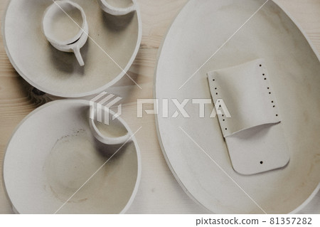 Decorative clay plates, on a wood background with copy space. Decorative clay plates, on a wood background with copy space. 81357282