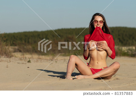 Feminine young sexy woman relaxing on sandy shore 81357883