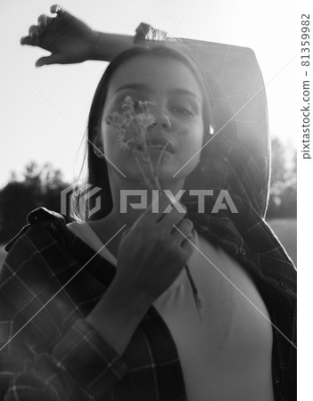 a happy girl with long black hair in a wheat field. He enjoys the happy moments of his life. 81359982