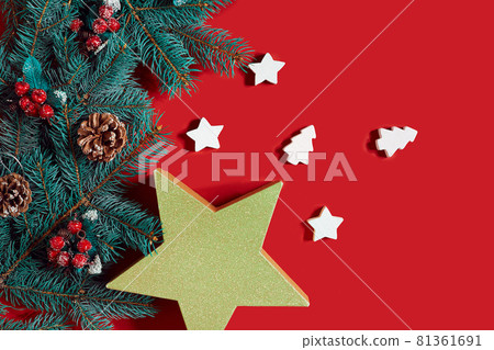 Christmas composition of pine cones, spruce branches and stack of gift boxes on red background 81361691