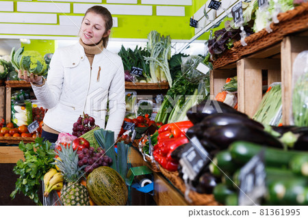 Woman looking for vegetables in farmers market 81361995