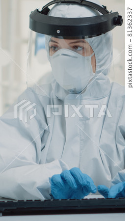 Dentistry specialist holding x ray while using computer Dentistry specialist holding x ray while using computer 81362337