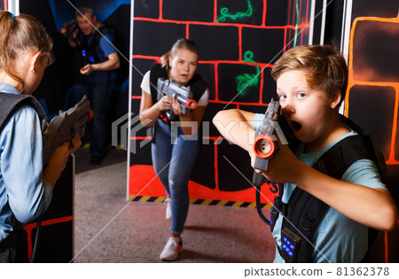 Teen boy playing laser tag 81362378