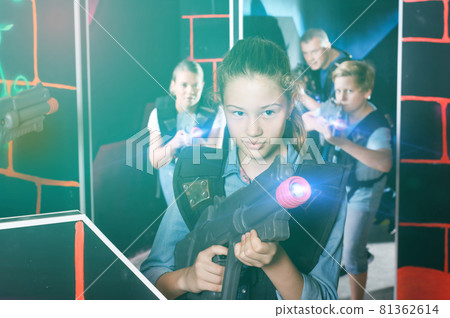Teen girl with laser pistol on dark labyrinth Teen girl with laser pistol on dark labyrinth 81362614