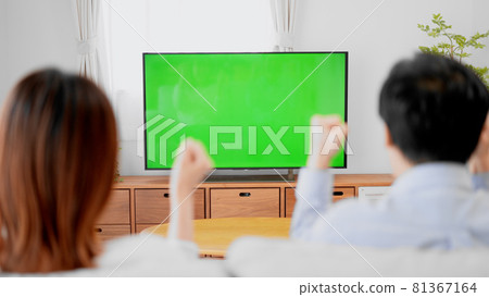 Chroma key composite image of men and women watching sports broadcasts 81367164