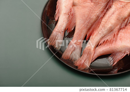 The split sea bass on a round plate black. The split sea bass on a round plate black. 81367714