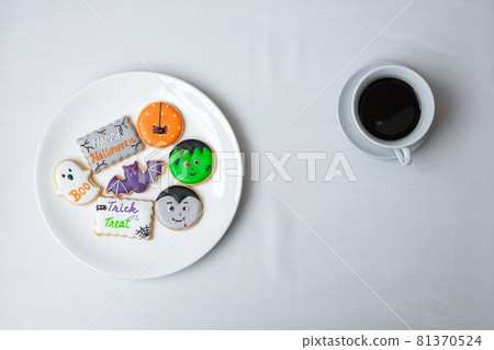 hot coffee cup with funny Halloween Cookies. Happy Halloween day, Trick or Threat, Hello October, fall autumn, Traditional, party and holiday concept 81370524