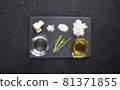 Ingredients for making focaccia - traditional Italian bread consist of yeast, Fleur de sel, sugar, flour, water, rosemary, olive oil - top view on the black background 81371855