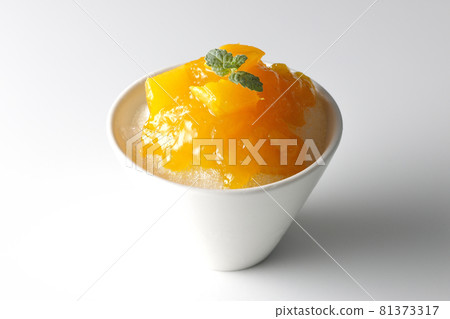 Photographed shaved ice with plenty of mango syrup with pulp on a white background 81373317