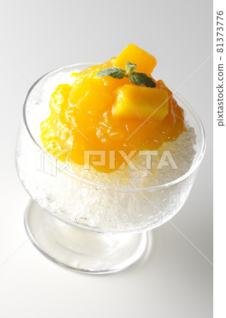 Photographed shaved ice with plenty of mango syrup with pulp on a white background 81373776