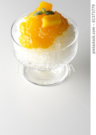 Photographed shaved ice with plenty of mango syrup with pulp on a white background 81373779