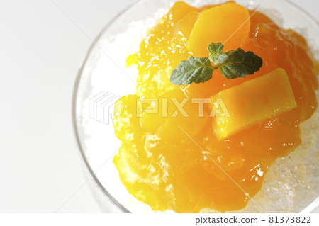 A bird's-eye view of shaved ice with plenty of mango syrup containing pulp on a white background 81373822