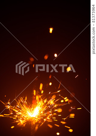 Christmas sparkler in haze with red light 81373964