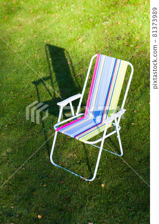 garden chair on green lawn background 81373989
