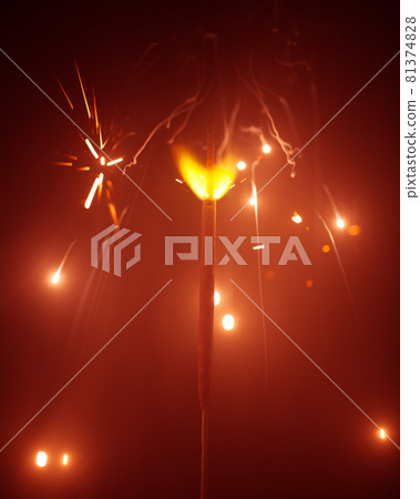 Christmas sparkler in haze with red light 81374828