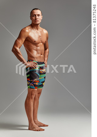 A portrait of an athlete in swimming trunks, in excellent athletic form, charismatic, adult, self-confident and charged to win. A portrait of an athlete in swimming trunks, in excellent athletic form, charismatic, adult, self-confident and charged to win. 81375248