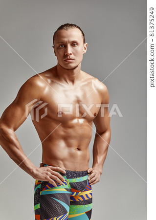 A portrait of an athlete in swimming trunks, in excellent athletic form, charismatic, adult, self-confident and charged to win. A portrait of an athlete in swimming trunks, in excellent athletic form, charismatic, adult, self-confident and charged to win. 81375249