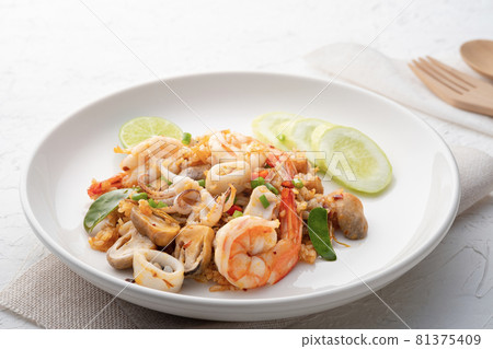 Seafood Tom Yum Fried Rice,Stir fried rice with shrimp squid and straw mushroom with sauce on white plate Seafood Tom Yum Fried Rice,Stir fried rice with shrimp squid and straw mushroom with sauce on white plate 81375409