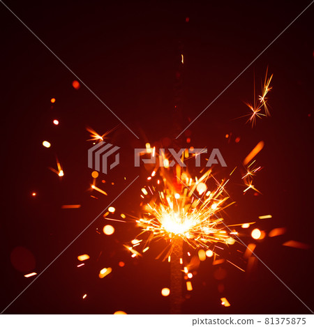 Christmas sparkler in haze with red light 81375875
